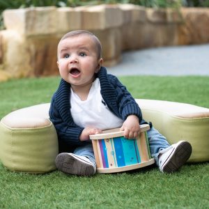 NoahSittingGrasswithToy